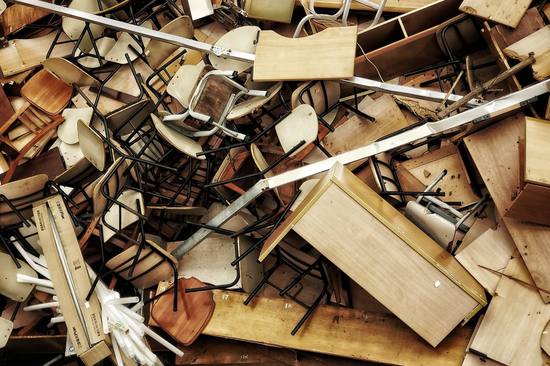 a pile of wooden chairs and chairs sitting on top of each other